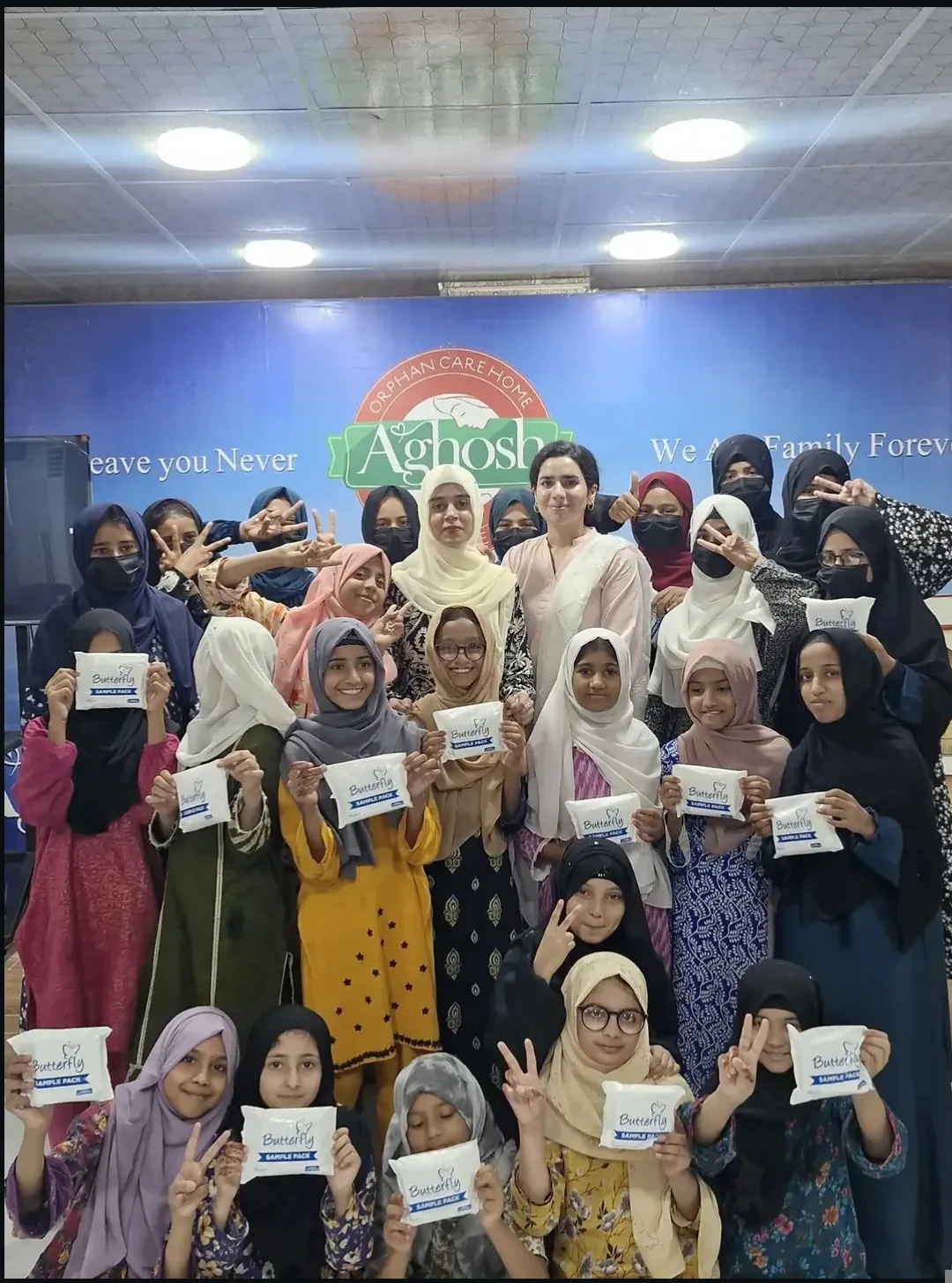 Girls at Aghosh Orphan Care Home holding sanitary pad packets after RFWO's menstrual health and hygiene session
